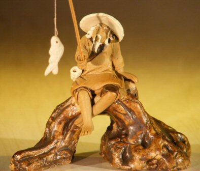 unknown Miniature Ceramic Fisherman Figurine<br>Fisherman Sitting On A Log - Unglazed