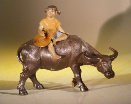 Miniature Figurine: Girl Riding on a Buffalo