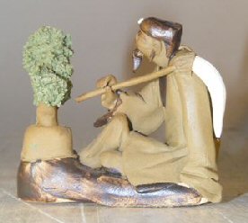 Ceramic Figurine: Man with Bonsai Tree Holding a Brush Image