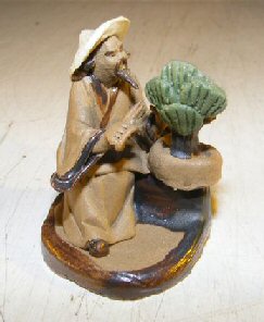 Man Trimming Bonsai TreeCeramic Mud Figurine Image