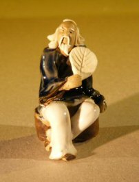 Miniature Figurine: Man Holding a Fan Sitting on a Rock - Blue Color - Fine Detail