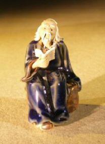 Miniature Figurine: Man Holding a Book Sitting on a Rock - Dark Blue Color - Fine Deta