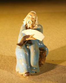 Miniature Figurine: Man Holding a Fan Sitting on a Rock<br>Light Blue Color - Fine Deta