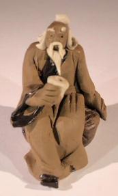 Miniature Figurine: Man Holding a Cup Sitting on a Rock - Light Brown Color 