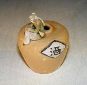 Miniature Ceramic Figurine: Man Sitting on Jar - Fine Detail<br><i>Measures 2.5