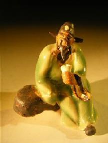 Ceramic Miniature Figurine Man on Bench Holding Drinking Cup