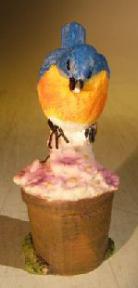 Miniature Bird Figurine<br><i></i>Sitting Atop Flowers In Garden Pot<br>