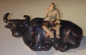 Ceramic Figure<br>Man Sitting On Sitting Buffalo<br>Large