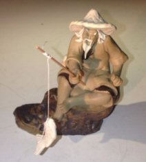 Ceramic Figurine <br>Mud Man Sitting On A Rock Fishing <br>