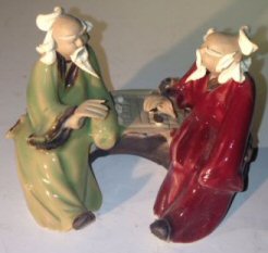 Ceramic Figurine<br>Two Men Sitting On A Bench<br>Color: Green & Red