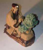 Ceramic Figurine<br> Mud Man Sitting On A Rock With His Bonsai Tree