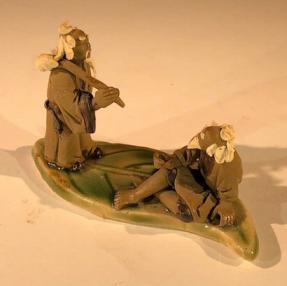 Miniature Ceramic Figurine <br>Two Mud Men On A Leaf, One Standing Holding a Bag, The Other Sitting - 2