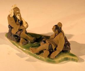 Miniature Ceramic Figurine <br>Two Mud Men On A Leaf, One Sitting Smoking a pipe, The Other Sitting - 2