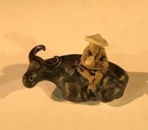 Ceramic Figure<br>Man Sitting On Sitting Buffalo<br>Small