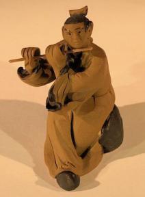 Ceramic Figurine<br> Mud Man Playing Flute - 2.5