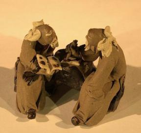 Miniature Ceramic Figurine<br>Two Mud Men Sitting On A Bench Reading Book and Scribing - 1.5