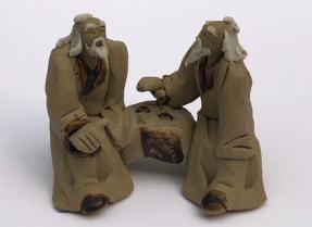 Ceramic Figurine<br>Two Mud Men Sitting On A Bench Playing Chess<br>2