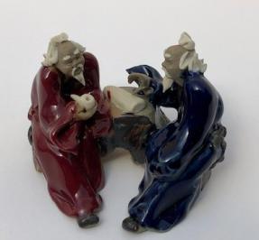 Ceramic Figurine<br>Two Men Sitting On A Bench Holding a Pipe- 2.25