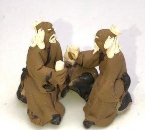 Miniature Ceramic Figurine<br>Two Mud Men Sitting On A Bench Drinking Tea - 1.5